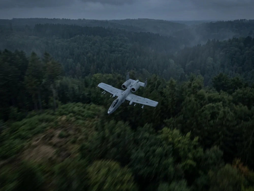 Synthetic aircraft sample above forest terrain with low light and motion blur